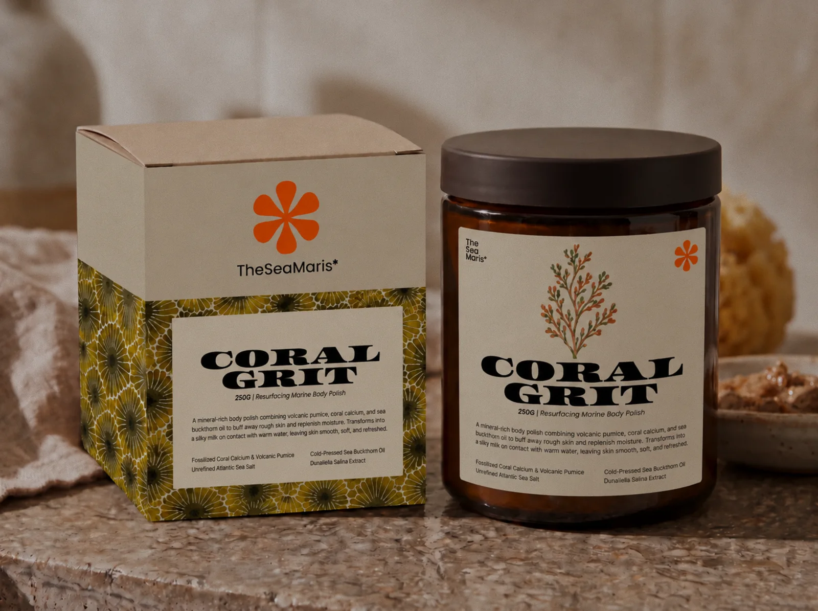 Coral Grit: an amber glass jar and its box wrapped in a fossil coral pattern, on a stone counter