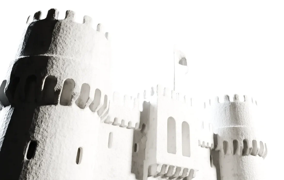 The plaster castle’s corner tower from below, its battlements catching the light