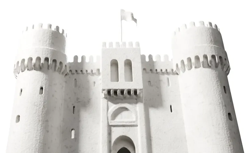 A white plaster castle, its gate between two round towers, a flag on the keep