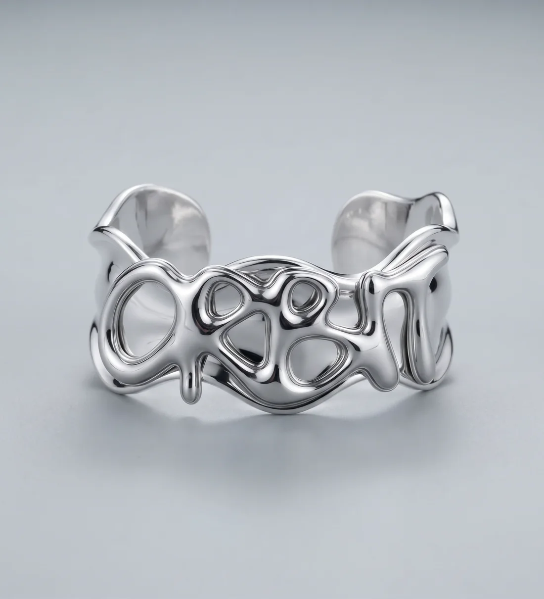 The Unda cuff, a rippled silver band with the ORBIT wordmark raised across it